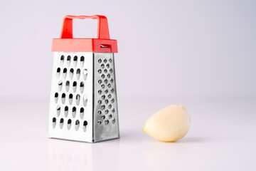 Garlic and grater on a white background. High quality photo