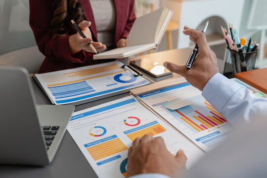 Business colleagues reviewing budget charts together in a modern office, focusing on financial insights, performance metrics, and strategic planning to support upcoming business decisions.