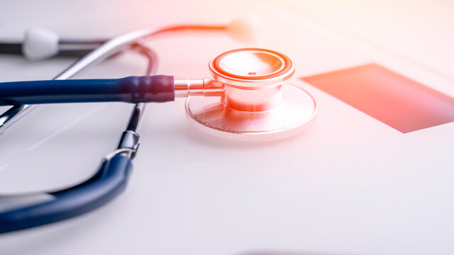 A stethophone and white electronic scale in close-up, in a studio photo. The idea of weight control for a healthy lifestyle, proper nutrition, and active recreation. - Powered by Adobe
