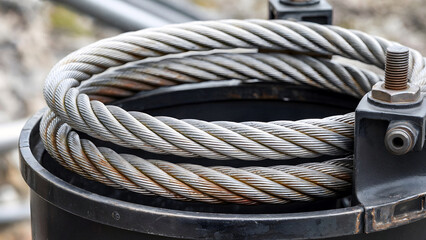 Heavy duty steel cables coiled in a industrial environment showcasing strength and reliability