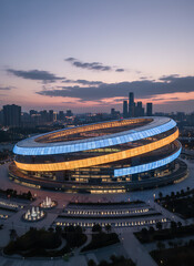 Stunning aerial view of modern city stadium illuminated at twilight hour