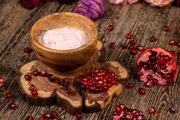 delicious fresh pink yogurt and ripe red pomegranate seeds, delicious pomegranate-flavored yogurt and fresh ripe red pomegranate