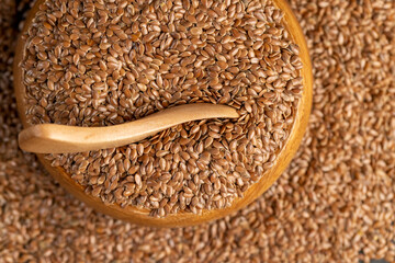 flax seeds poured into a bowl, a round wooden bowl completely filled with flax seeds, which can be used both for nutrition and for obtaining a new crop