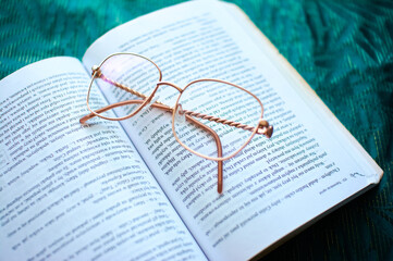 glasses on a book, learning and business © Mariusz