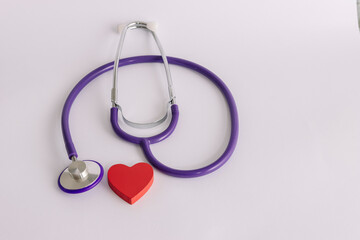 Fototapeta premium Stethoscope with red heart symbolizing cardiovascular health medical care heart disease prevention concept