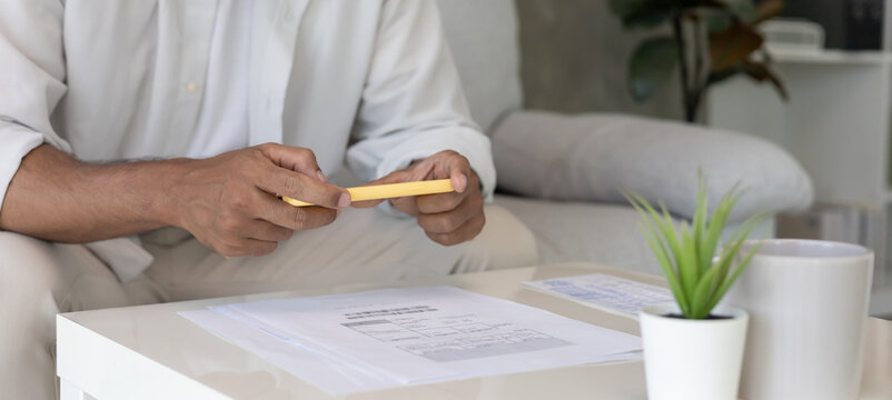 business man use phone to scan barcode or QR codes to pay credit card bill after receiving document invoice online. payment, receive, paying electricity, digital payments without money, technology