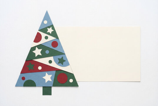 Paper cutout Christmas tree with geometric ornaments on white background, festive holiday card mockup with copy space for seasonal greetings and minimalist winter design