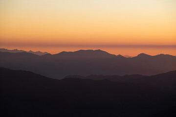 Fototapeta premium Watching the sunrise from the Kaçkar Mountains. Sunrise from Kaçkar Peak. Hiking towards Kaçkar Peak in the early morning. Magnificent view from Kaçkar Peak. Rize, Türkiye. 