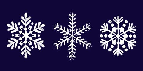 Three white grunge snowflakes on dark blue background for winter holidays