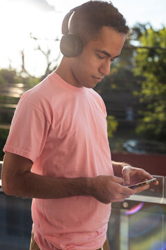 Contemporary man finding calm in music while checking his phone