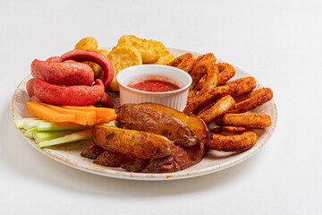 Enjoy grilled sausages, crispy potato wedges, and fresh veggie sticks with sauce