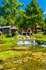 Fototapeta premium Old wooden mills Mlincici near Jajce on Plivsko Lake, Bosnia and Herzegovina, popular tourist attraction
