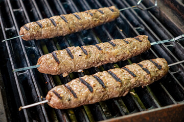 Perfectly shaped kebabs grill over hot coals, filling the air with delicious aromas during summer