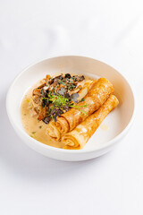 Savory crepes with creamy mushroom sauce and fresh herbs to delight your taste buds