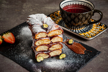 Sweet pastries are arranged with tea and strawberries, creating a delightful scene