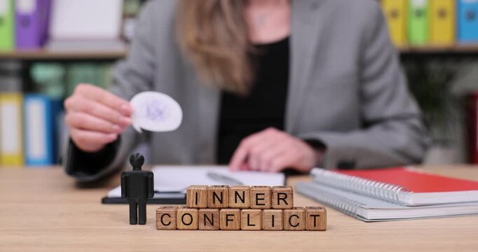 Exploring inner conflict through mindful reflection with thought-provoking visuals in a calm workspace