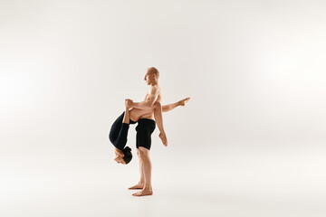 Obraz premium Dynamic duo showcases breathtaking acrobatic moves in a vibrant studio setting