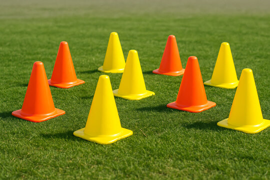 Colorful soccer training cones on grass field