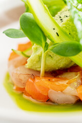 Delicate layers of shrimp and vegetables topped with creamy avocado, a feast for the senses