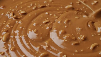 Delicious Homemade Chocolate Fudge Being Stirred in a Bowl CloseUp View of the Creamy Texture and Nutty Ingredients Perfect for Dessert Lovers and Confectionery Enthusiasts.