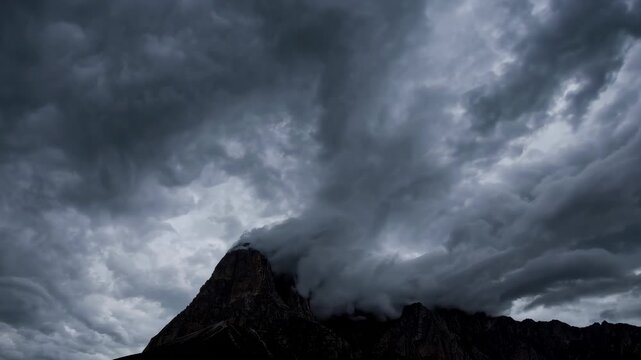 Dramatic dark cloud sky over majestic mountain peak, moody atmosphere, nature landscape, powerful and intense scene, wilderness adventure