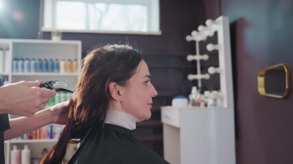 stylist arranging hair, preparing and sectioning elegant hairstyle, stylist skillfully sections hair for refined updo, calm salon environment as stylist assembles hair into neat segments