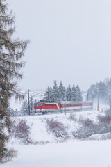 Train traveling through snowy winter landscape in Slovakia