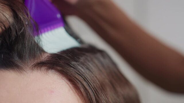 stylist application with protective measures, detailed root bleaching with careful salon preparations, closeup of chemical treatment for hair regrowth coverage with controlled tone