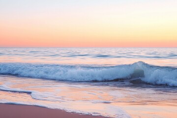 Naklejka premium Peaceful ocean scene with gentle waves rolling onto sandy shore under soft pastel sunset sky, creating calm and soothing atmosphere by water