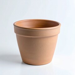 A pristine, empty terracotta pot with a classic flared rim, featuring warm reddish-brown tones against a minimalist white backdrop.