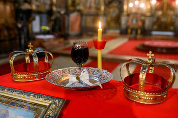 Two crowns, a cup of wine and a cross prepared for baptism