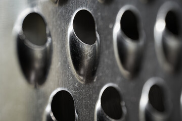 Close-up of a metal grater's sharp texture