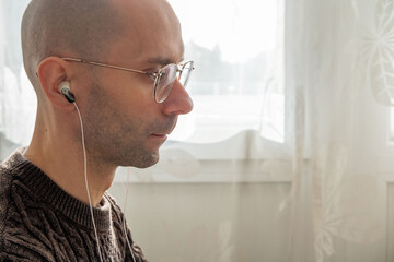Programmer, young man in brown cable knit sweater working at computer, coding process, modern worker solving problems, specialist digital tasks, home office environment promoting productivity and calm