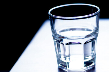 Clear glass with pure cold drinking water on table