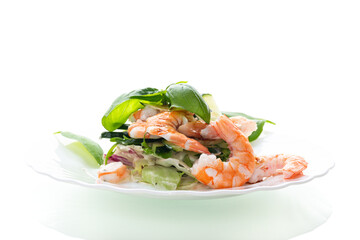 Appetizing salad with shrimps on a white background