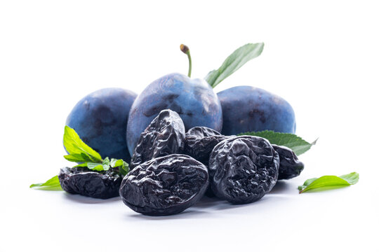 Natural blue plums and dried prunes with leaves