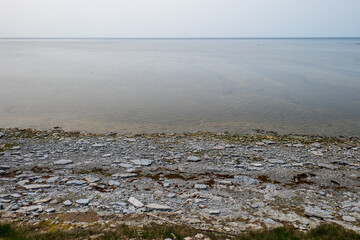 Calm Ocean, Low Tide and Overcast Sky at Sunset Creating a Minimalist Coastal Landscape in Saint Claire's Bay, Anticosti Island, Quebec, Canada