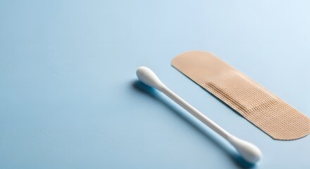 Essential medical cotton swab and bandage on a light blue background for National Blood Donor Month concept and post-donation care