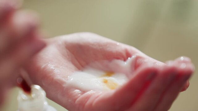 closeup of nourishing skincare process, detail shot of hair treatment being prepared with serum and lotion, close view of hands applying nourishing hair serum and lotion for shine and repair