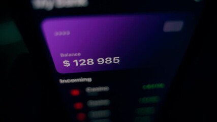 Fictional mobile app of a bank account with a growing balance in the account due to casino earnings. Gambling games that bring money. Dark background - Powered by Adobe