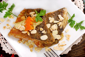 Carp fillets fried with almond flakes for Christmas