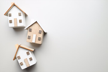 Minimalist wooden house models on blank background