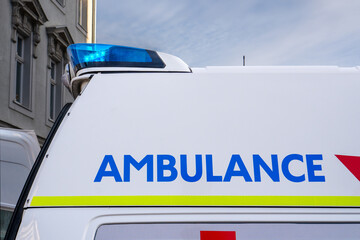 Close-up of an ambulance with blue lights on on the roof and the Ambulance lettering on the side © Doris Steiner
