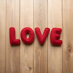 love word of plush red letters on wood background
