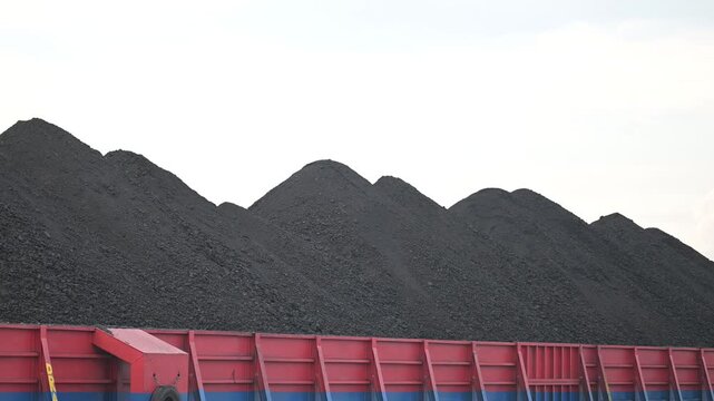 Berau - Indonesia, 25 August 2025 : pontoon loading coal with white clouds in the background
