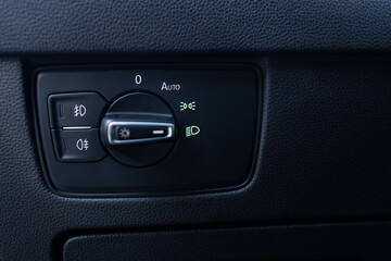Headlight switch, on off mode lights, automatic control of switching on and off the car light. Mode of lamp electric car. Lights switch cars, car interior. Modern LED Car IQ Headlights.