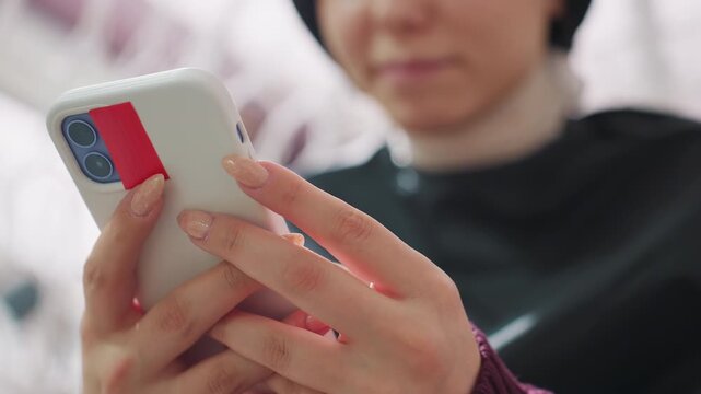 closeup of mobile transaction process, focus on fingers interacting with phone screen during payment, detailed shot of fingers tapping phone screen to complete electronic payment indoors