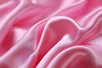 Obraz premium Close up macro shot of soft pink satin fabric with gentle folds and curves