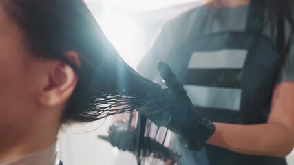 stylist applying treatment, applying hair care products professionally, expert stylist quickly coats damp hair with products, skilled hairdresser distributes treatment evenly on moist hair swiftly