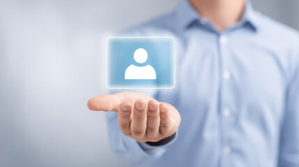 A person holds a digital representation of a user icon in their hand, symbolizing technology and networking.